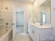 Bright bathroom featuring double sinks, a large mirror, and a tub/shower combo with white cabinets and fixtures at 450 Bent Burr Crk, York, SC 29745
