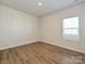 Cozy bedroom with wood-look floors, a window, and neutral paint, creating a serene space at 450 Bent Burr Crk, York, SC 29745