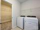 Convenient laundry room with washer, dryer, and shelving for efficient organization at 450 Bent Burr Crk, York, SC 29745