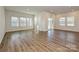 Bright living room with wood-look floors, large windows, and a sliding glass door to the yard at 450 Bent Burr Crk, York, SC 29745