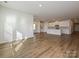 Open-concept living space with a kitchen island, white cabinets, and ample natural light at 450 Bent Burr Crk, York, SC 29745