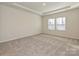 Comfortable main bedroom with carpet, a tray ceiling, and two windows for ample natural light at 450 Bent Burr Crk, York, SC 29745