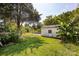 View of the backyard showcasing green space with a garage at 455 Wood Ave, Kannapolis, NC 28083