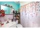 Bathroom with a vintage sink, mirrored cabinets, and a floral-themed shower curtain at 455 Wood Ave, Kannapolis, NC 28083