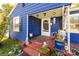 Charming blue home featuring a cozy front porch and decorative landscaping at 455 Wood Ave, Kannapolis, NC 28083