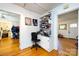 Home office featuring a desk, built-in shelving, and hardwood floors at 455 Wood Ave, Kannapolis, NC 28083