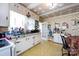 A bright kitchen with a double basin sink, classic cabinetry, and vintage-style wallpaper at 455 Wood Ave, Kannapolis, NC 28083