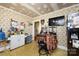 Kitchen showcasing a refrigerator, floral wallpaper, checkered-patterned floor, and flat screen TV at 455 Wood Ave, Kannapolis, NC 28083