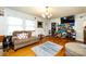 A cozy living room with hardwood floors, light-filled windows, and comfortable seating arrangement at 455 Wood Ave, Kannapolis, NC 28083