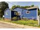 Blue single-story home exterior with a chain-link fence at 455 Wood Ave, Kannapolis, NC 28083