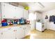 Utility room with washer, dryer, built-in cabinets, and a laundry sink area at 455 Wood Ave, Kannapolis, NC 28083