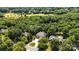 Captivating aerial view of brick home with sprawling lawn and landscaping amidst mature trees at 4740 Myers Ln, Harrisburg, NC 28075