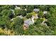 An aerial view of a brick home surrounded by trees with back deck at 4740 Myers Ln, Harrisburg, NC 28075