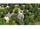 Bird's-eye view of brick home with deck and wooded surroundings provides secluded feel at 4740 Myers Ln, Harrisburg, NC 28075