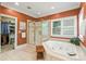 Bathroom featuring a jacuzzi tub, shower, and separate walk-in closet at 4740 Myers Ln, Harrisburg, NC 28075