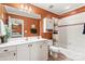 Bathroom with white vanity, large mirror, shower-tub combination, and rust-colored walls at 4740 Myers Ln, Harrisburg, NC 28075