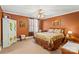 Comfortable bedroom with warm colors, hardwood furniture, and natural light at 4740 Myers Ln, Harrisburg, NC 28075