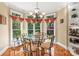 Bright breakfast nook with a glass table, hardwood floors, and large windows at 4740 Myers Ln, Harrisburg, NC 28075