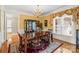 Formal dining room features decorative rug, chandelier, and large window at 4740 Myers Ln, Harrisburg, NC 28075