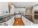 Bright kitchen features stainless steel appliances, granite countertops and hardwood floors at 4740 Myers Ln, Harrisburg, NC 28075