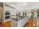 Gourmet kitchen with a large island, stainless steel appliances, and hardwood floors at 4740 Myers Ln, Harrisburg, NC 28075