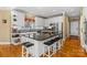Spacious kitchen island featuring black countertops, seating for four, and white cabinets at 4740 Myers Ln, Harrisburg, NC 28075
