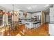 Open-concept kitchen with white cabinetry, a large island, and a breakfast nook at 4740 Myers Ln, Harrisburg, NC 28075