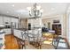 Open concept kitchen with white cabinets, granite countertops, and stainless appliances at 4740 Myers Ln, Harrisburg, NC 28075
