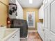 Functional laundry room with modern washer, dryer, sink, and storage cabinets at 4740 Myers Ln, Harrisburg, NC 28075