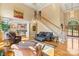 Spacious living room with a staircase, hardwood floors, and plenty of natural light at 4740 Myers Ln, Harrisburg, NC 28075