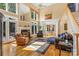 Spacious living room with fireplace, tall windows, and comfortable seating at 4740 Myers Ln, Harrisburg, NC 28075