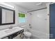Bright bathroom features a sleek vanity, modern fixtures, and a combined tub and shower with white tiling at 4906 Charleston Dr, Charlotte, NC 28212