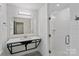 Modern bathroom featuring a sleek vanity and glass shower stall lined with subway tiles and stainless fixtures at 4906 Charleston Dr, Charlotte, NC 28212