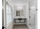 Sleek bathroom featuring a vanity and standing glass shower stall with subway tiles and a tile floor at 4906 Charleston Dr, Charlotte, NC 28212