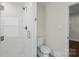Tiled bathroom features a glass shower stall and a low-flow toilet with updated fixtures at 4906 Charleston Dr, Charlotte, NC 28212