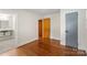 This bedroom has hardwood floors with dual entrances to a connected room and an ensuite bathroom at 4906 Charleston Dr, Charlotte, NC 28212