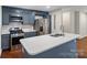 Modern kitchen with stainless steel appliances, blue cabinets, and center island at 4906 Charleston Dr, Charlotte, NC 28212