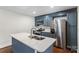 Modern kitchen with stainless steel appliances and a blue island at 4906 Charleston Dr, Charlotte, NC 28212