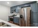 Modern kitchen with stainless steel appliances, blue cabinets, and a center island at 4906 Charleston Dr, Charlotte, NC 28212