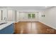 Open living space with hardwood floors and a kitchen view with a blue island at 4906 Charleston Dr, Charlotte, NC 28212