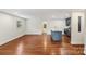 Open-concept living room with hardwood floors and a view into the kitchen at 4906 Charleston Dr, Charlotte, NC 28212