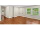 Bright living room featuring hardwood floors, white walls, and natural light at 4906 Charleston Dr, Charlotte, NC 28212