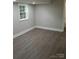 Well-lit basement bedroom featuring hardwood flooring and neutral paint at 518 N Fulton St, Salisbury, NC 28144