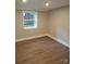 Basement bedroom with hardwood flooring and a window providing natural light at 518 N Fulton St, Salisbury, NC 28144