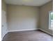 Cozy bedroom with hardwood flooring, neutral paint, and a window providing natural light at 518 N Fulton St, Salisbury, NC 28144