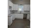 Bright kitchen featuring white cabinets, granite countertops, subway tile backsplash and modern fixtures at 518 N Fulton St, Salisbury, NC 28144
