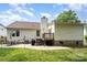 A large backyard with patio and lawn for outdoor enjoyment at 5843 Timber Falls Nw Pl, Concord, NC 28027