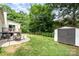 A backyard with patio, lawn, privacy fence and an outbuilding at 5843 Timber Falls Nw Pl, Concord, NC 28027