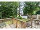 A wooden deck overlooks the backyard with an outbuilding in the distance at 5843 Timber Falls Nw Pl, Concord, NC 28027
