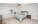 This bedroom offers natural light from the window and features neutral paint and carpet at 5843 Timber Falls Nw Pl, Concord, NC 28027